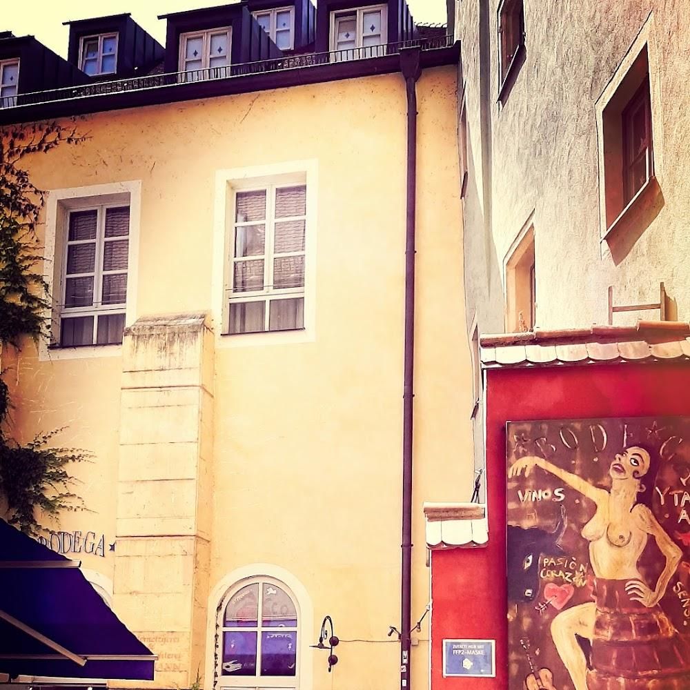 A yellow building with a mural of a woman on the side.